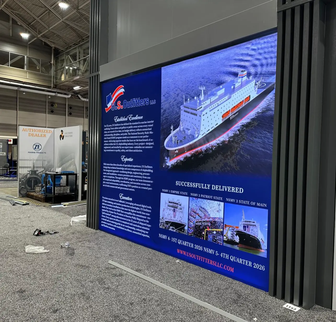 Side profile of a slim-frame LED lightbox display featuring a 3D digital twin shipyard visualization.